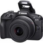 Canon EOS R100 mirrorless camera with RF-S 18-45mm lens angled view on white background