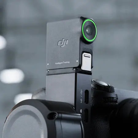 DJI RS Enhanced Intelligent Tracking Module mounted on a compatible RS gimbal showing green tracking status ring