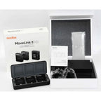 Godox MoveLink II M2 two-person wireless microphone charging case and three units beside original retail box