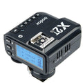 Godox X2T-N Nikon TTL wireless trigger three-quarter view showing LCD group buttons and hotshoe