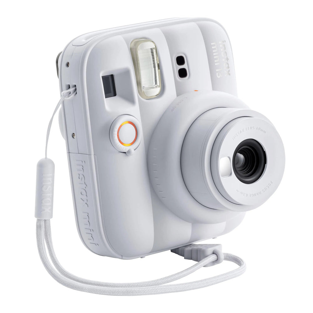 Fujifilm Instax Mini 13 Clay White front three-quarter view and wrist strap