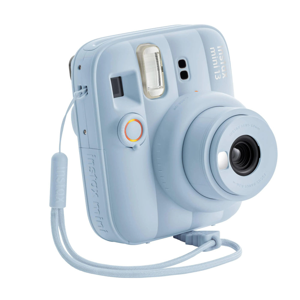 Fujifilm Instax Mini 13 Frost Blue camera three-quarter view with strap