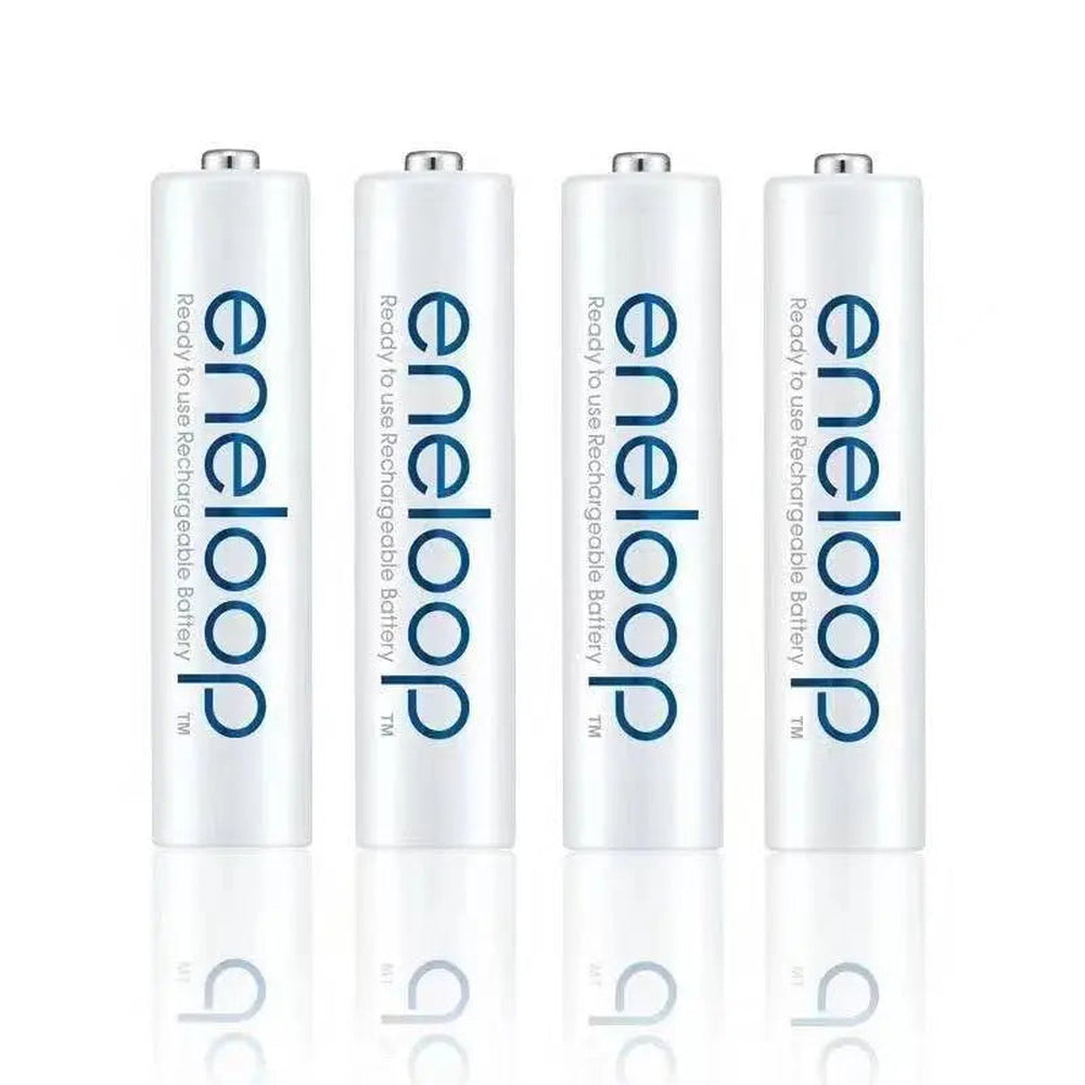 Four white Panasonic Eneloop rechargeable AA batteries standing in a row