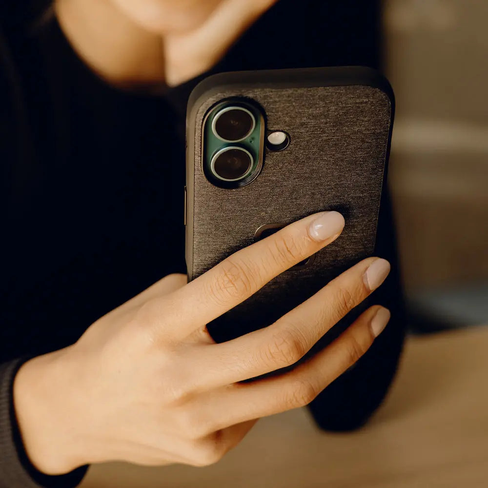 Peak Design Everyday Fabric Case for iPhone 16 Plus – Charcoal lifestyle view in hand