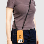Peak Design Mobile Crossbody Phone Strap worn crossbody with smartphone