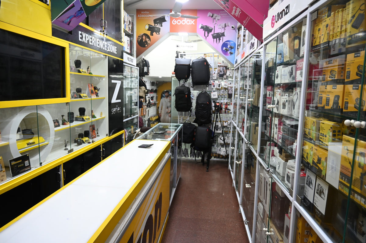 Main aisle at Royale Stores in Fort, Mumbai, with camera displays and photography accessories